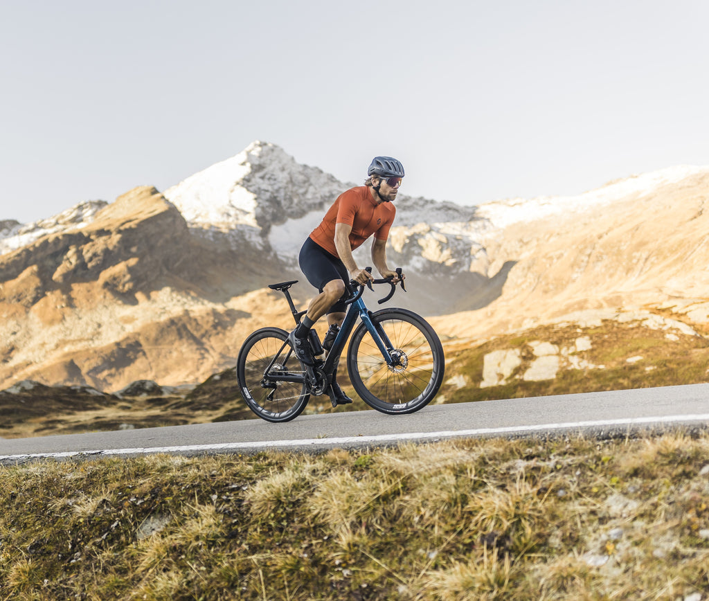 man riding a bike up hill