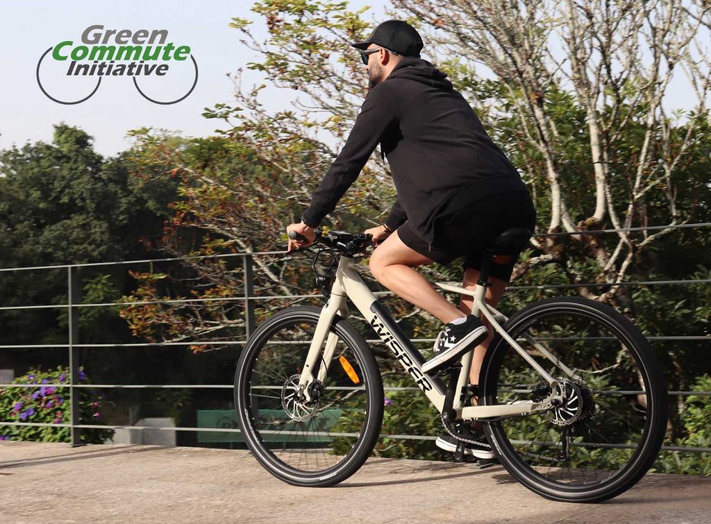 man riding a wisper ebike - green commute initiative